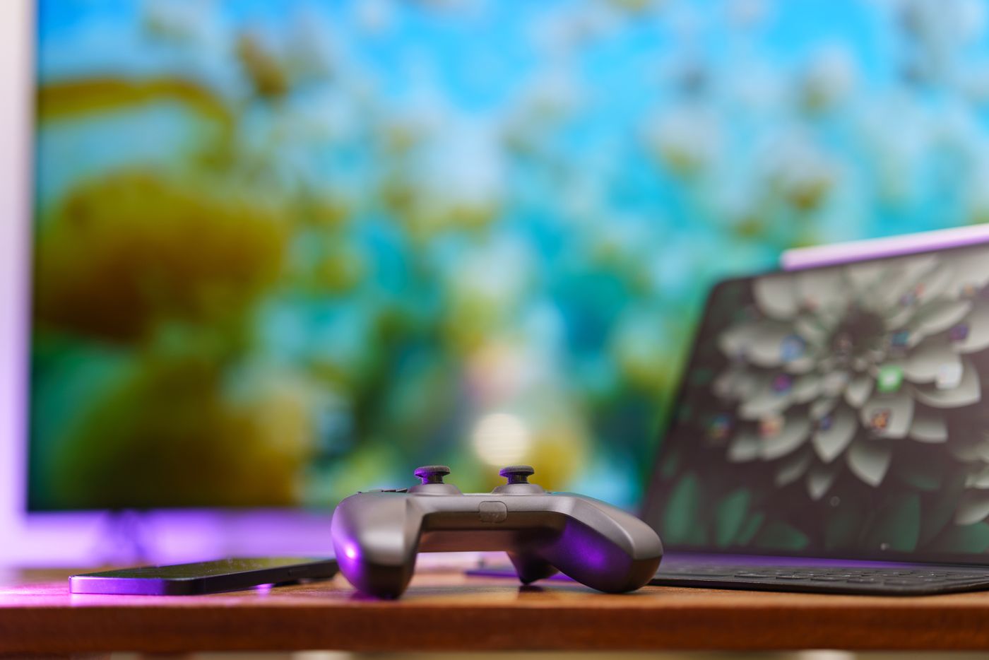 A controller in front of a colourful gaming screen