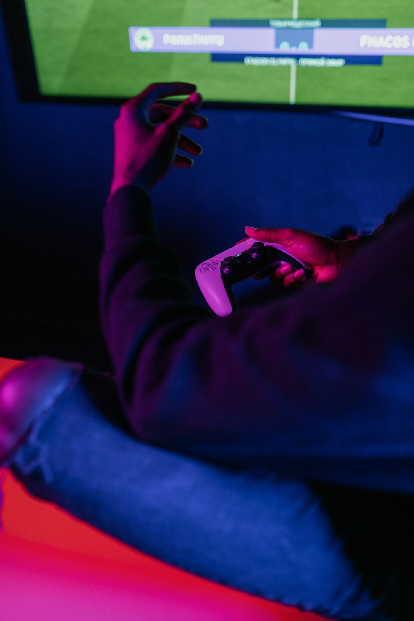 Player gaming under neon lights