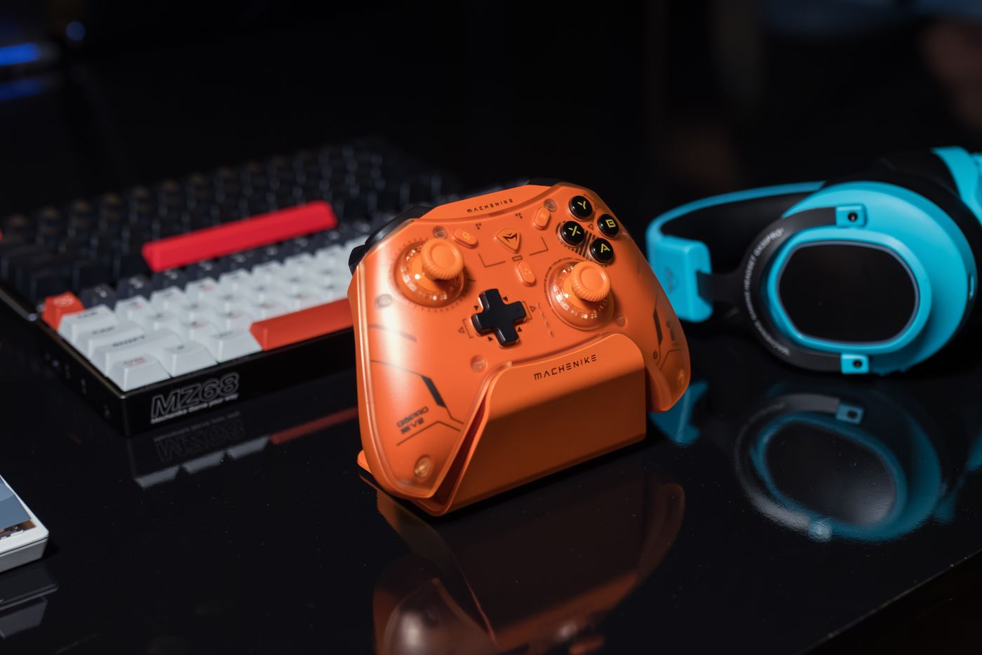 Orange controller beside a keyboard